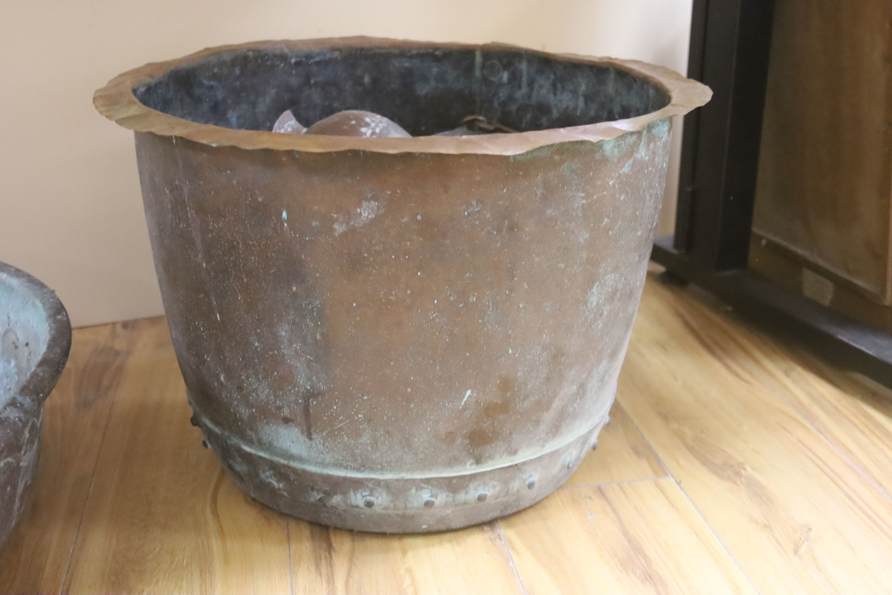 Two large copper bowls and related items, largest 54 cms diameter.